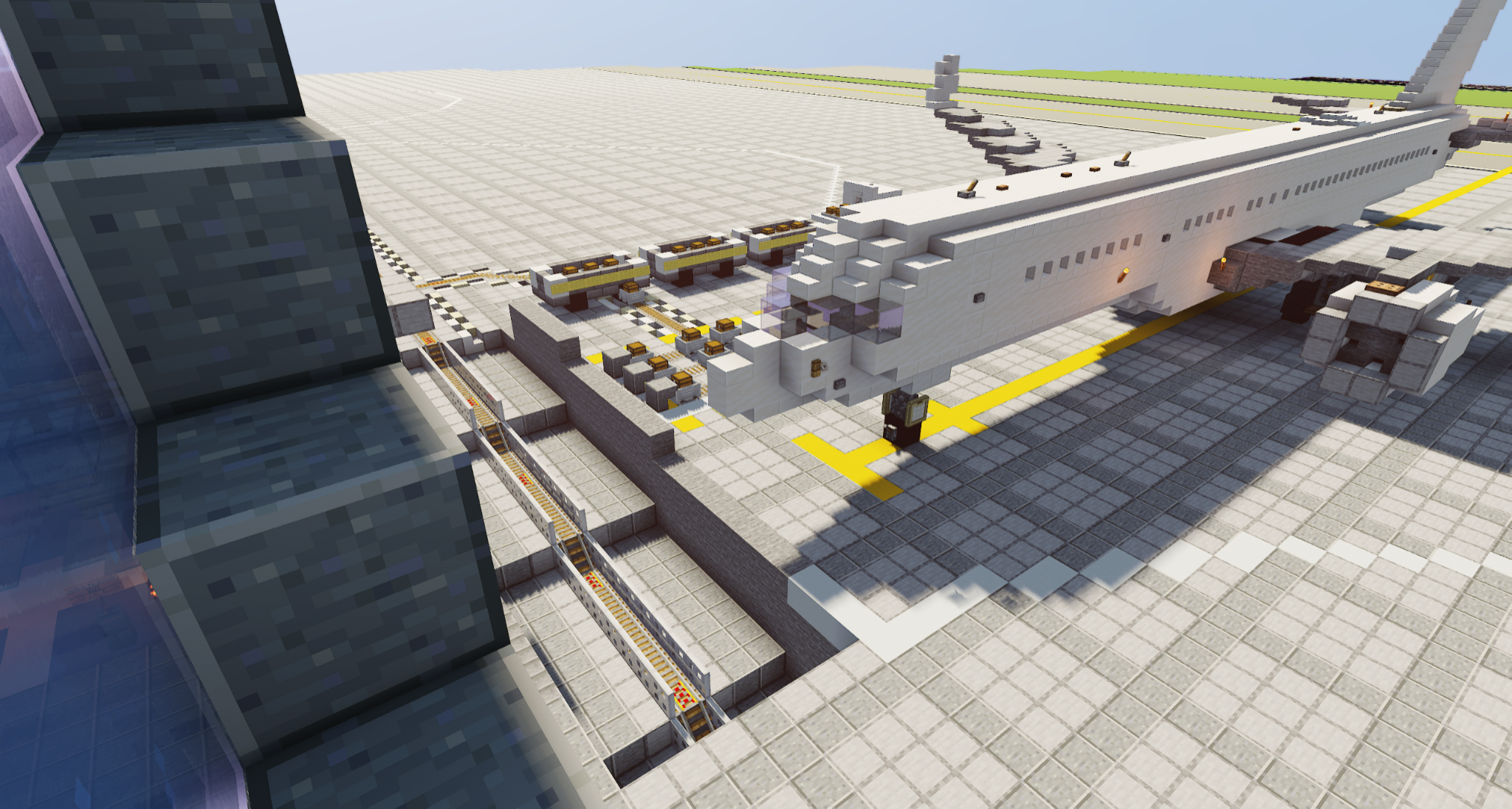 The picture shows a peaceful Minecraft scene on a sunny day. At the center of the shot is a small airport with a large passenger plane parked on the tarmac. The plane, a Boeing 737, is white with blue accents and looks ready to take off. The airport itself is very large, but it has all the important facilities such as a runway, hangars and even a small control tower.